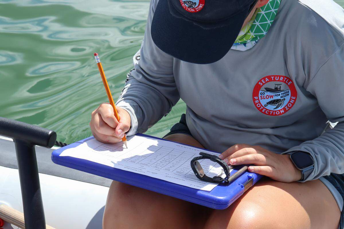 A researcher from Mote Marine Laboratory records boat speeds in Sarasota Bay on Thursday, Sept. 21, 2023. The data collected is part of Mote’s Sea Turtle Protection Zone initiative.