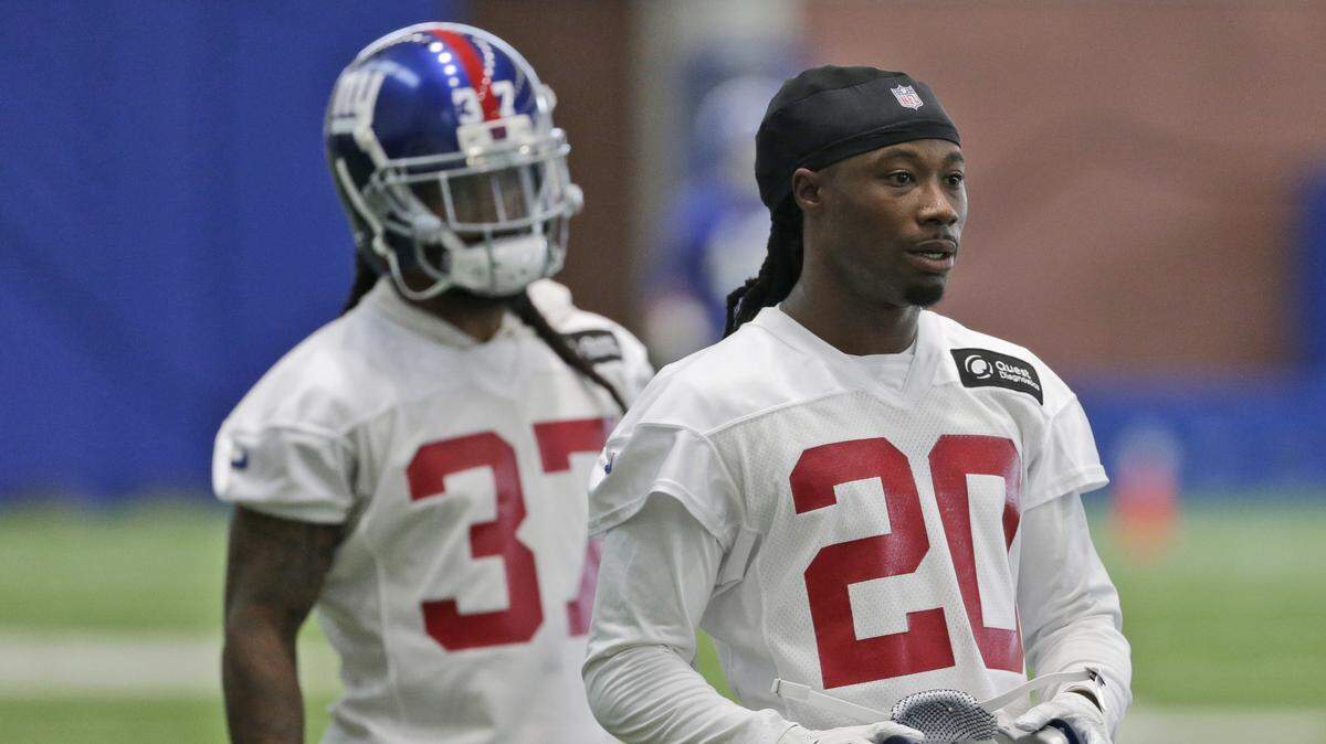 New York Giants' Janoris Jenkins, right, takes off his helmet during practice at the NFL football team's training camp in East Rutherford, N.J., on Monday, June 4, 2018.