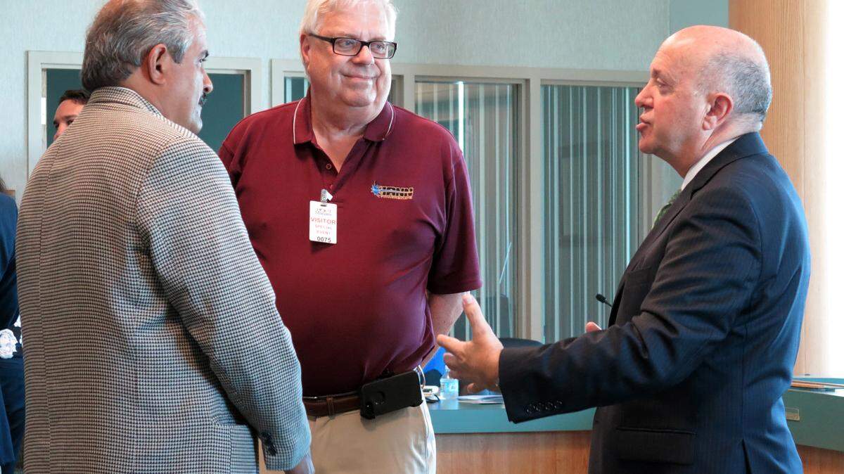 Carlos Buqueras, executive director of Port Manatee, talks with Hann Powerboats Vice President Kevin McLaughlin and YP.com representative Jose Marin at an international trade roundtable held at the port Wednesday. MATT M. JOHNSON/Bradenton Herald