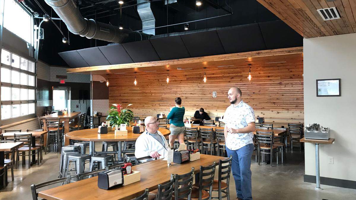 Dylan Kennedy visits with a customer at Maple Street Biscuit Company, 8491 Cooper Creek Blvd., unit 107, in University Park.