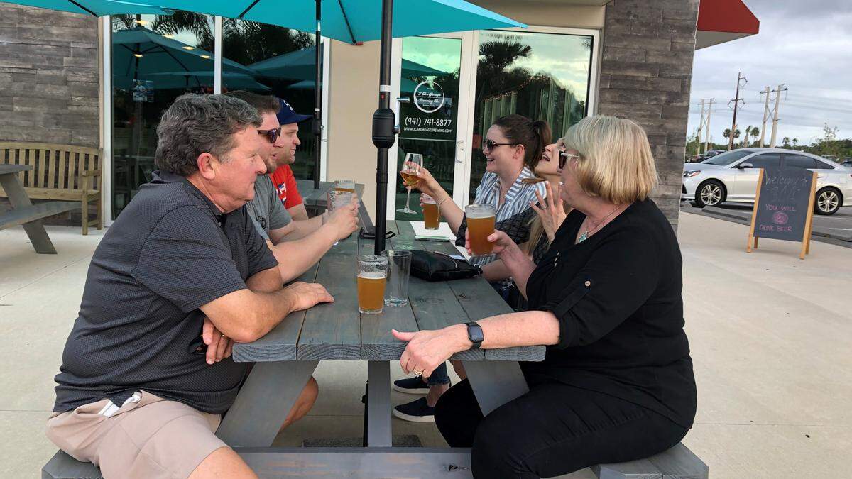 Guests enjoy craft beer on the patio of 3 Car Garage Brewing, which opened recently at 8405 Heritage Green Way, Bradenton.