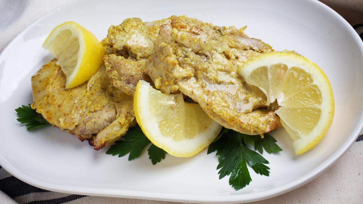 Tandoori chicken thighs are served hot with lemon wedges.DEB LINDSEY/THE WASHINGTON POST