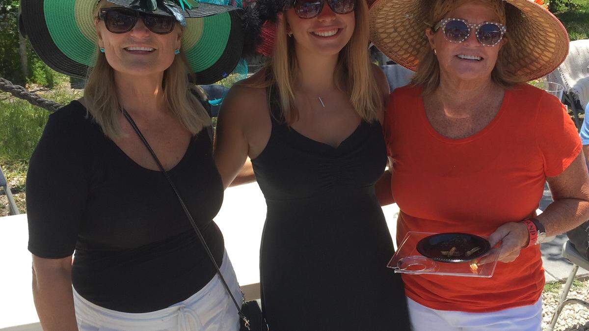 From left: Robyn Thompson, Sami Bierman and Annie Radick of Holmes Beach sport Kentucky Derby chapeaus Saturday at Food and Wine on Pine.CHRIS WILLE/Bradenton Herald