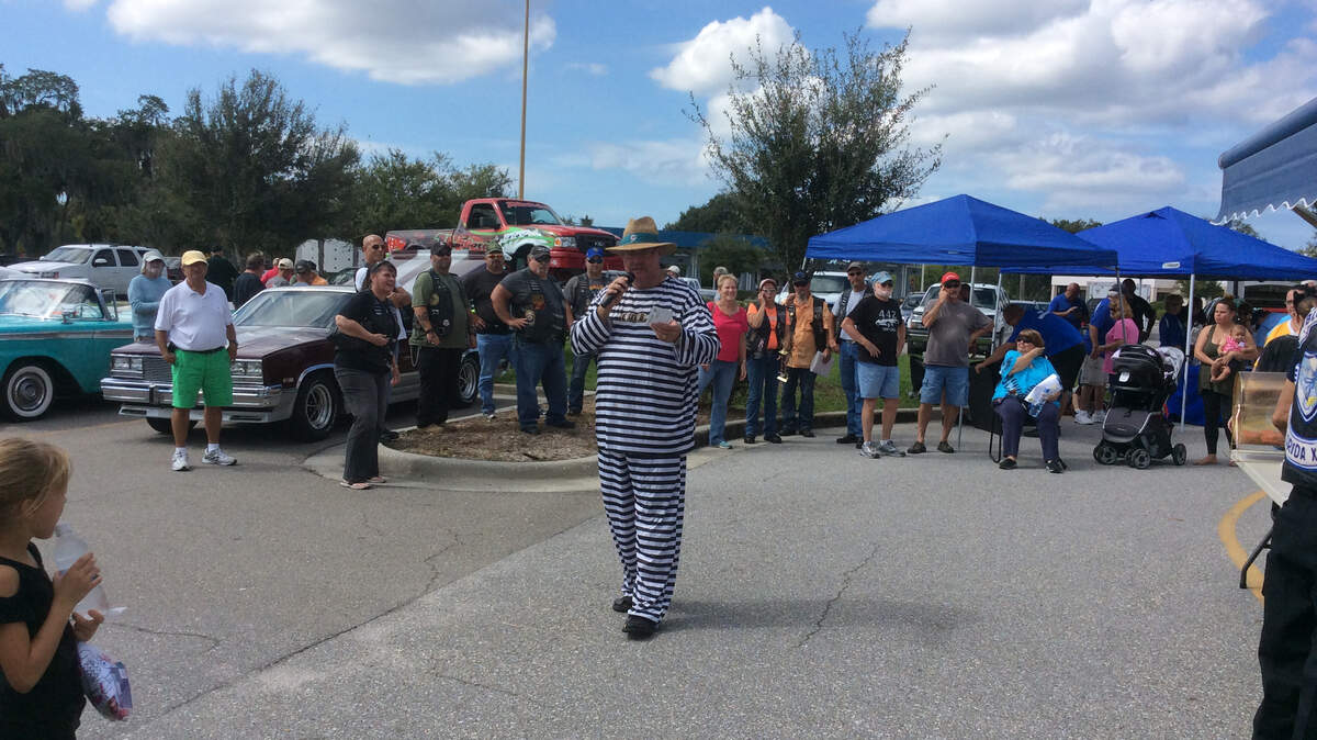Sgt. Dwayne Dennison announces the winners of the car and motorcycle show at the Flight to the North Pole benefit Saturday.JESSICA DE LEON/ Bradenton Herald