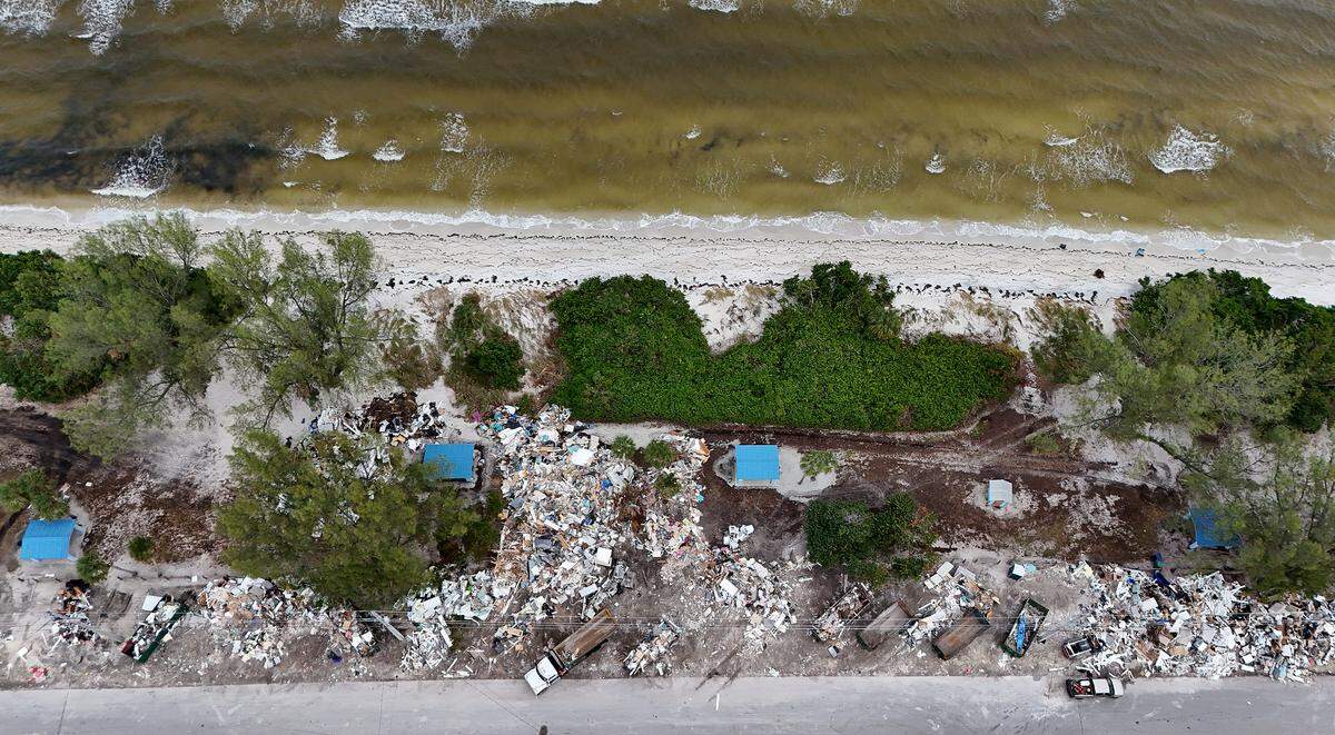 A massive amount of storm debris is stacked on N. Bay Drive on Anna Maria Island where dump trucks come haul away loads as Hurricane Milton approaches Manatee County on Oct. 8, 2024.