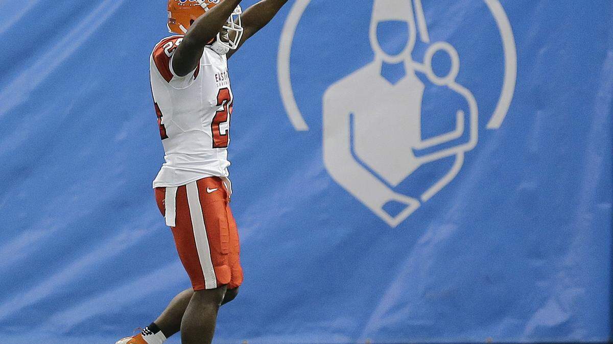 East cornerback Brian Poole, of Florida, celebrates after intercepting a West pass and returning it for a touchdown during the first half of the East West Shrine game Saturday in St. Petersburg. Poole was a standout at Southeast High School. CRis O'Meara/Associated Press