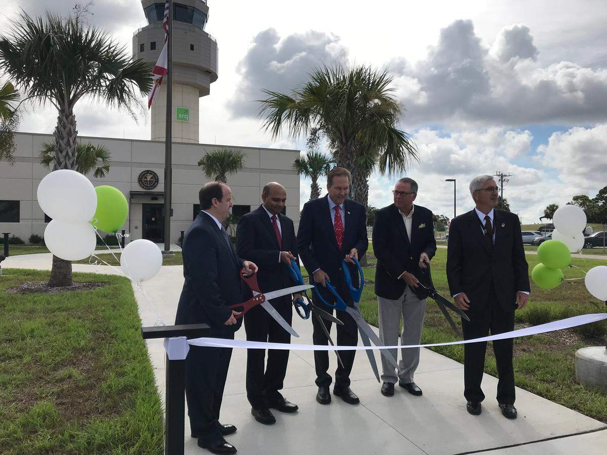 Taking part in the dedication of the $25 million air traffic control tower at SRQ Monday were, from left, Michael O’Harra, FAA regional administrator,  L. K. Nandam, FDOT District One secretary, U.S. Rep. Vern Buchanan, Bob Spencer, chairman of the Sarasota Manatee Airport Authority, and Rick Piccolo, president and CEO of Sarasota Bradenton International Airport.