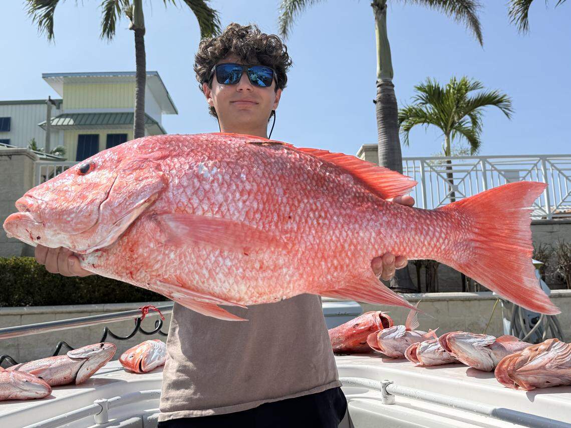 Angler Tony Figlozzi poses with a tagged 34-inch red snapper caught fishing with Captain Brian Lambert.