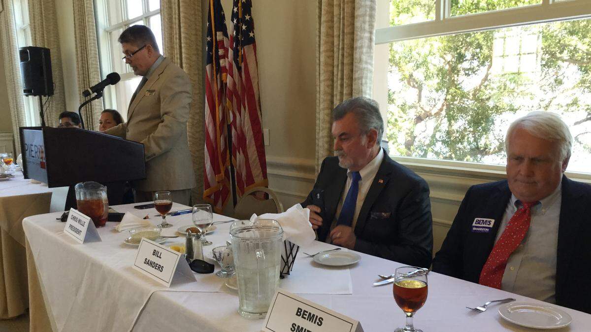 From the right, incumbent Ward 4 City Councilman Bemis Smith and his challenger Bill Sanders get ready to trade verbal punches at Thursday’s Tiger Bay Club candidate luncheon. Tiger Bay president Chris Willie moderated the event.