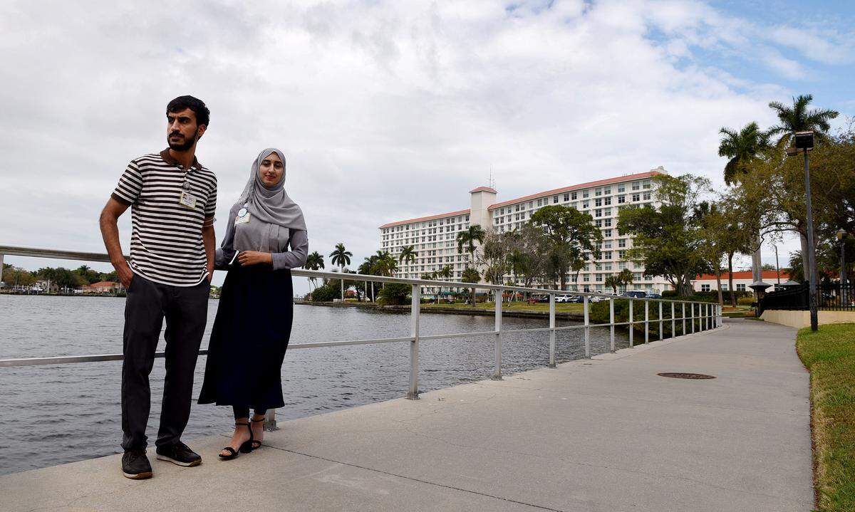 Noman Raoufi and his sister, Venus, at Westminster where they both now work after immigrating from Afghanistan.