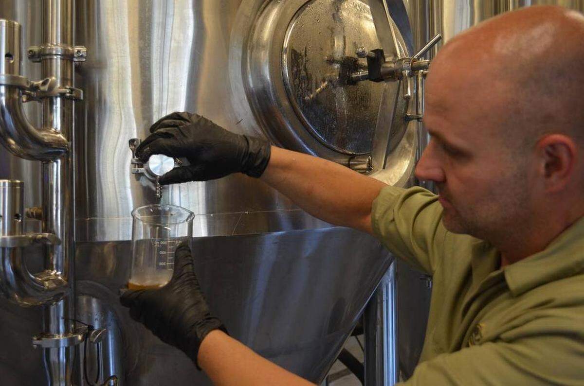 Mike Krail opens a tap at Good Liquid Brewing Company in 2017.