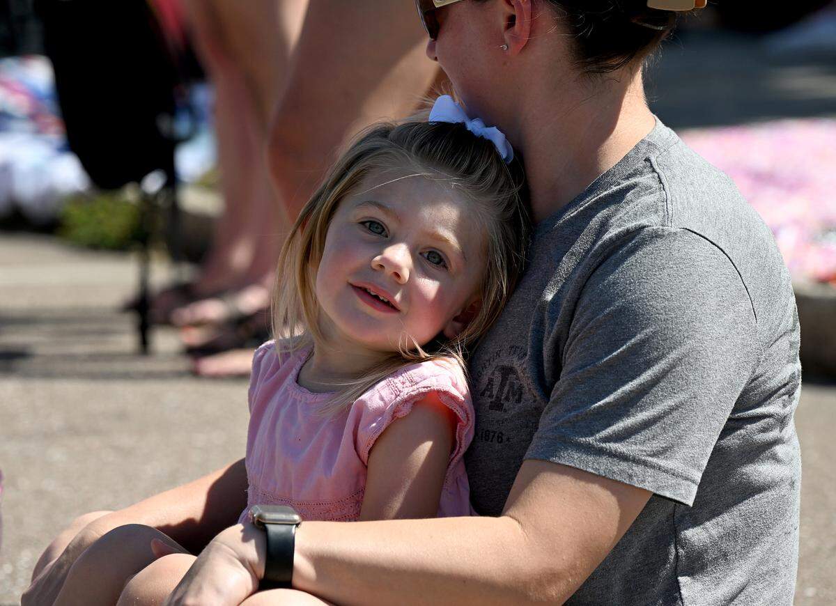 A little girl enjoys the fun from a comfy seat at the annual DeSoto Children’s Parade and Party in the Park in Palmetto on April 18, 2025.