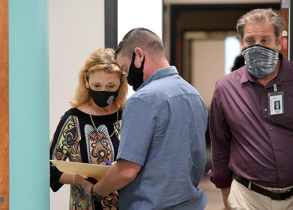 02/18/21--Bryan Kitchner, a special agent with the FDLE served subpoenas to four commissioners ahead of ThursdayÕs public work session meeting. Commissioner Vanessa Baugh receives her subpoena.