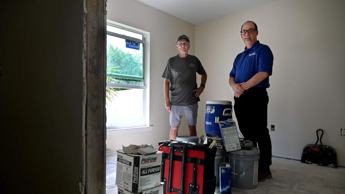Greg Kisela, president and CEO of Our Next Mission (left), and Bernie Quinn, president and CEO of Manatee County Habitat for Humanity (right), in a Palmetto home that is being remodeled to house a local veteran.