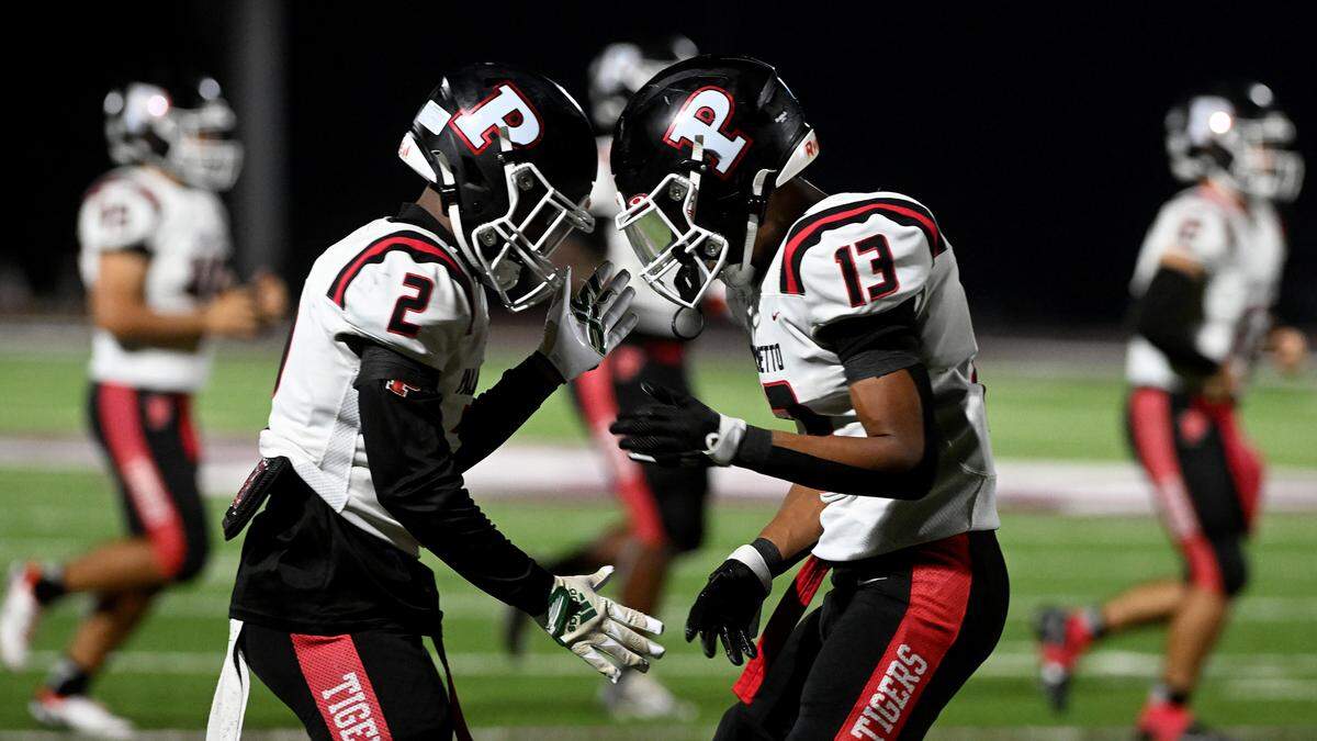 Palmetto’s Jamari Parker celebrates a touchdown with teammate Rok Lodge during the FHSAA playoff game in Sarasota Friday, Nov. 10.