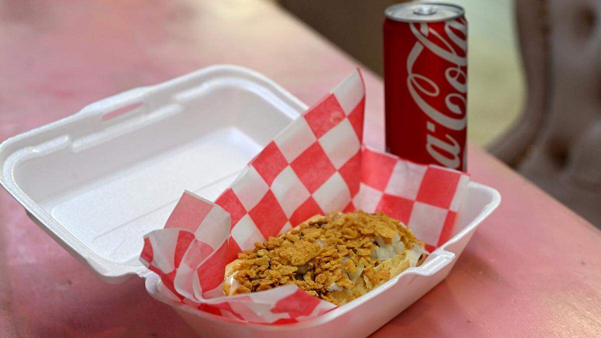 The Pink Coney dog has spicy brown mustard, meslted white cheddar, chili, diced raw onions and corn chips on top at the Pink Coney Club, 5306 Holmes Boulevard Ste 810 in Holmes Beach.