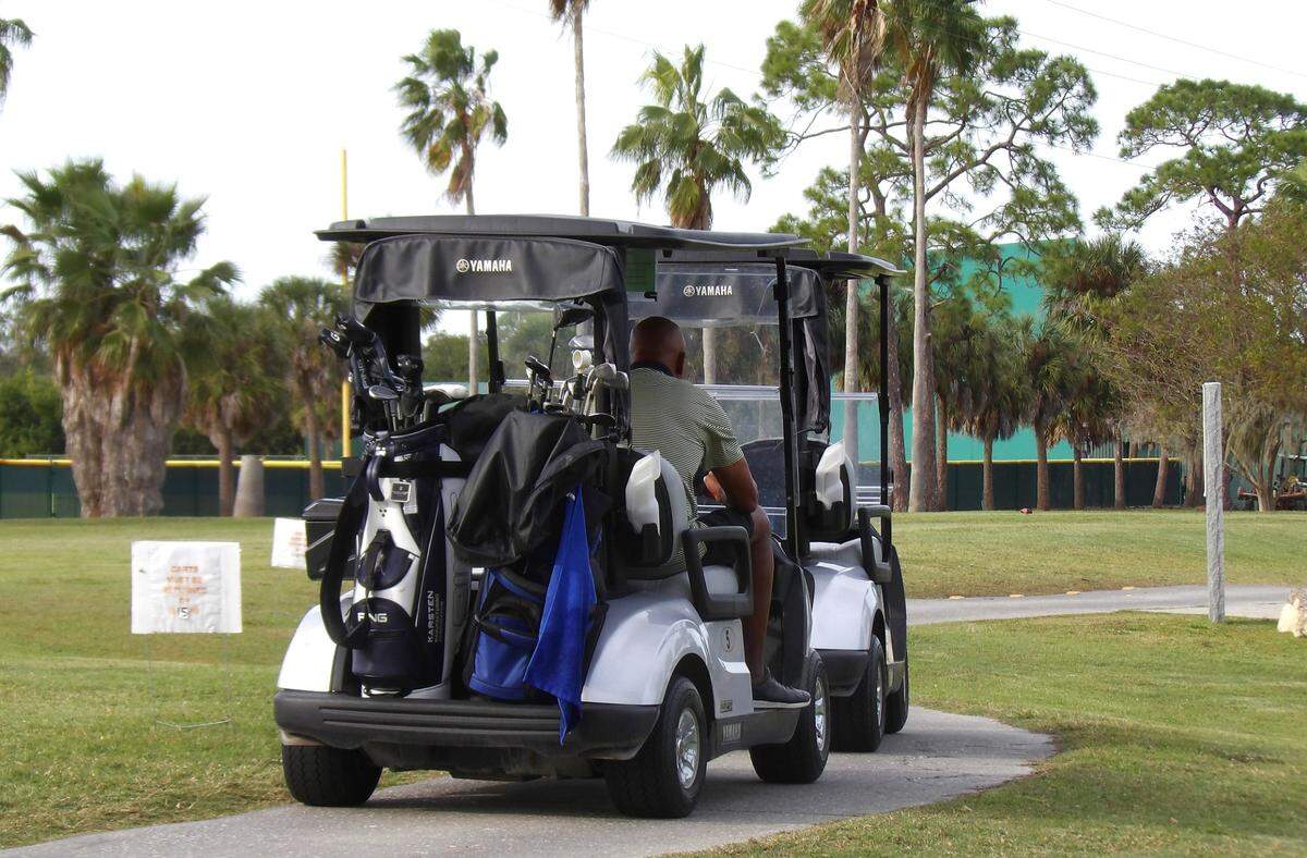 Two golf carts head out after teeing off on the 10th hole at the River Run Golf Links course owned by the city of Bradenton.