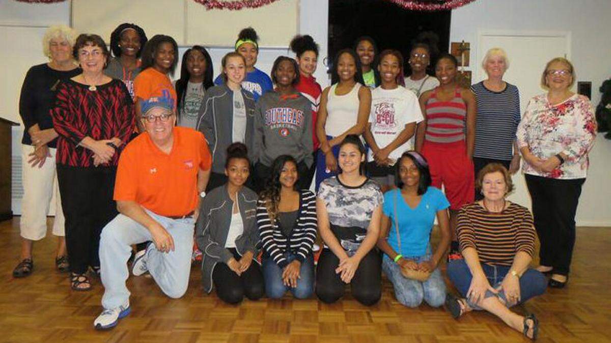 The women of Gloria Dei Lutheran Church in Holmes Beach pose with members of the Southeast High School girls basketball team at a Christmas party. PROVIDED PHOTO