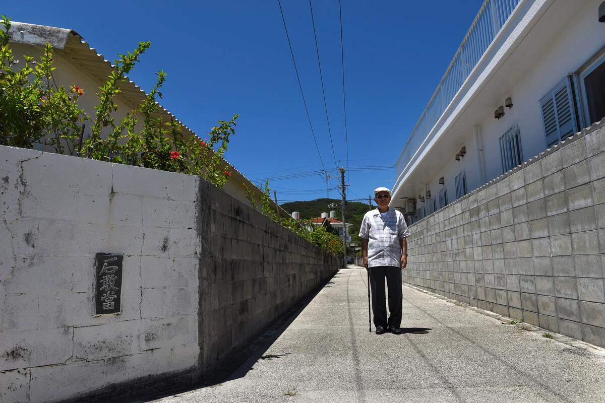 Takeichi Kakinohana, 86, on Aka Island where the American military landed during the Battle of Okinawa and where, eventually, the Japanese ceremonially surrendered. Takeichi and other islanders hid in the mountains, behind him, when the Americans landed.