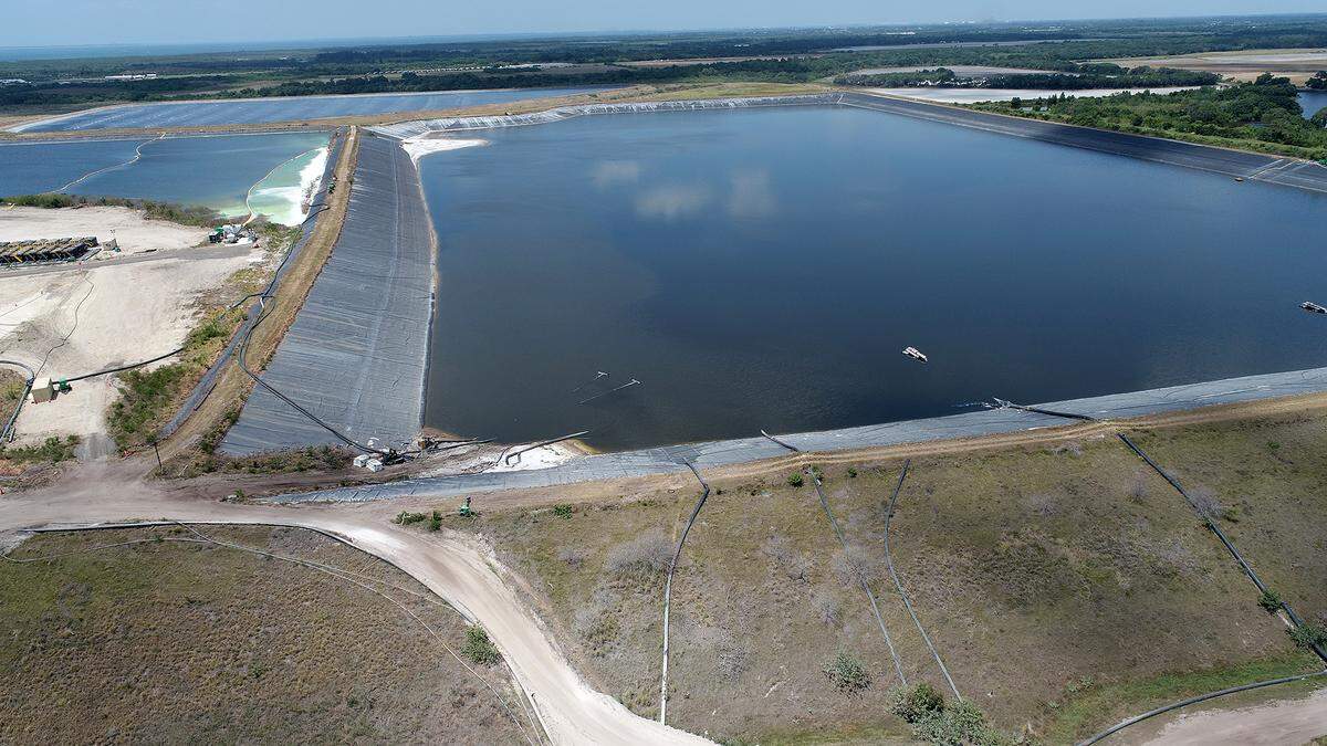 05/25/21—An aerial view shows Piney Point’s largest pond that threatened disaster after site operators found a tear in late March. It took a heavy steel plate, an underwater rover and more than 600 truckloads of sand to finally patch the torn liner at Piney Point and prevent the pond from leaking.