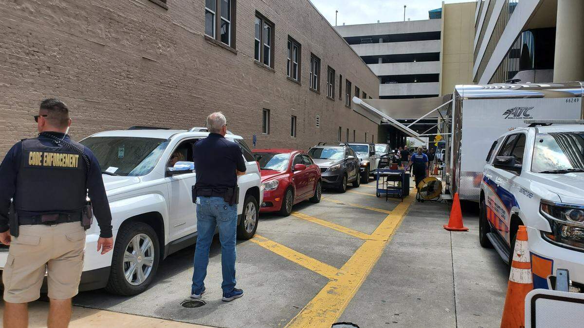 People wait in their cars for monitoring after getting vaccinated against the coronavirus on Friday at a drive-thru vaccine event held in downtown Bradenton.