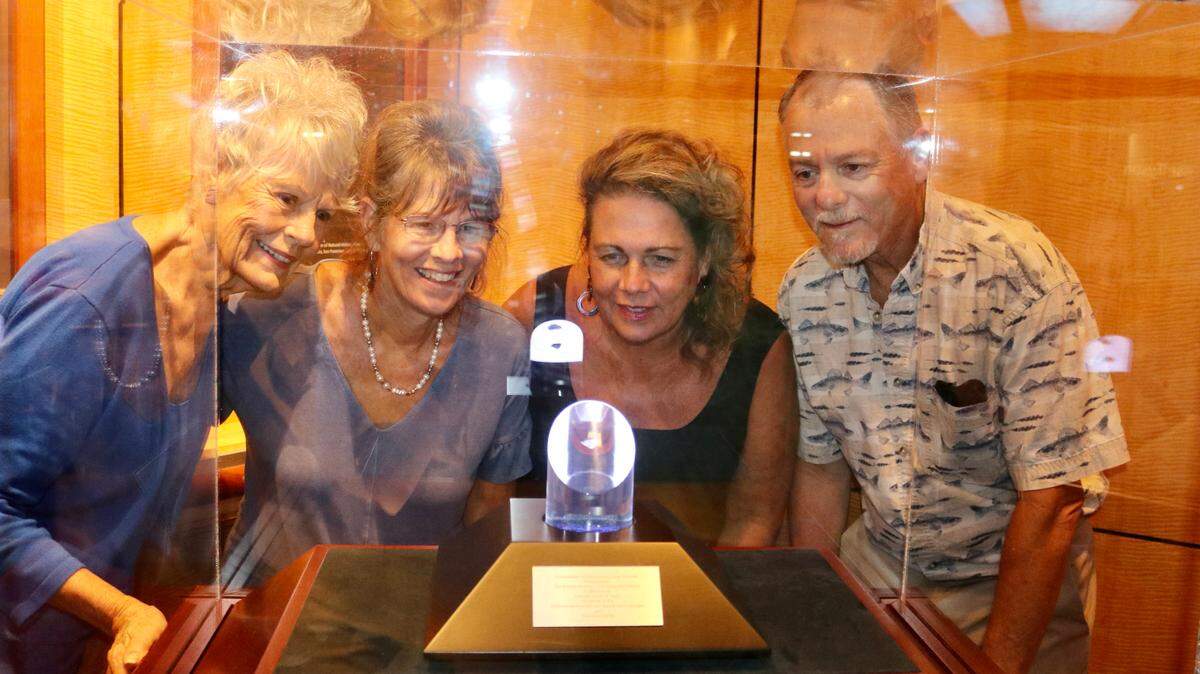 8/4/2021--The family of Apollo 15 astronaut Jim Irwin, the lunar module pilot who also drove the lunar rover, gather around his NASA Ambassador of Exploration Award that was unveiled Wednesday at The Bishop Museum of Science and Nature. From left are Mary Ellen Irwin-Vickers, Jill Irwin Christensen, Joy Irwin Schtakleff and Jim Irwin II.