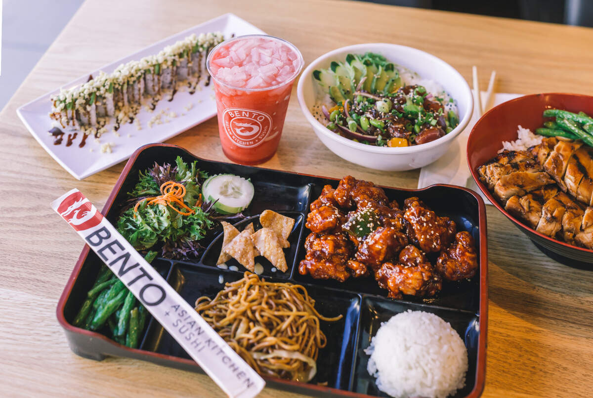 This Bento food spread includes, clockwise from top left, Bamboo Roll, Strawberry Slush with lychee jellies, Sriracha Garlic Bento Box, Hawaiian Poke Bowl, Teriyaki Chicken Rice Bowl, Sriracha Garlic Bento Box.