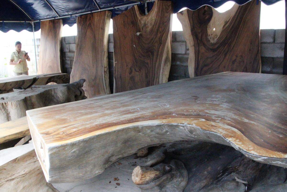 Celeste Gruenstein shows some of the wood rescued by Decor Direct that is being repurposed into unique-one-of-a-kind pieces of furniture.