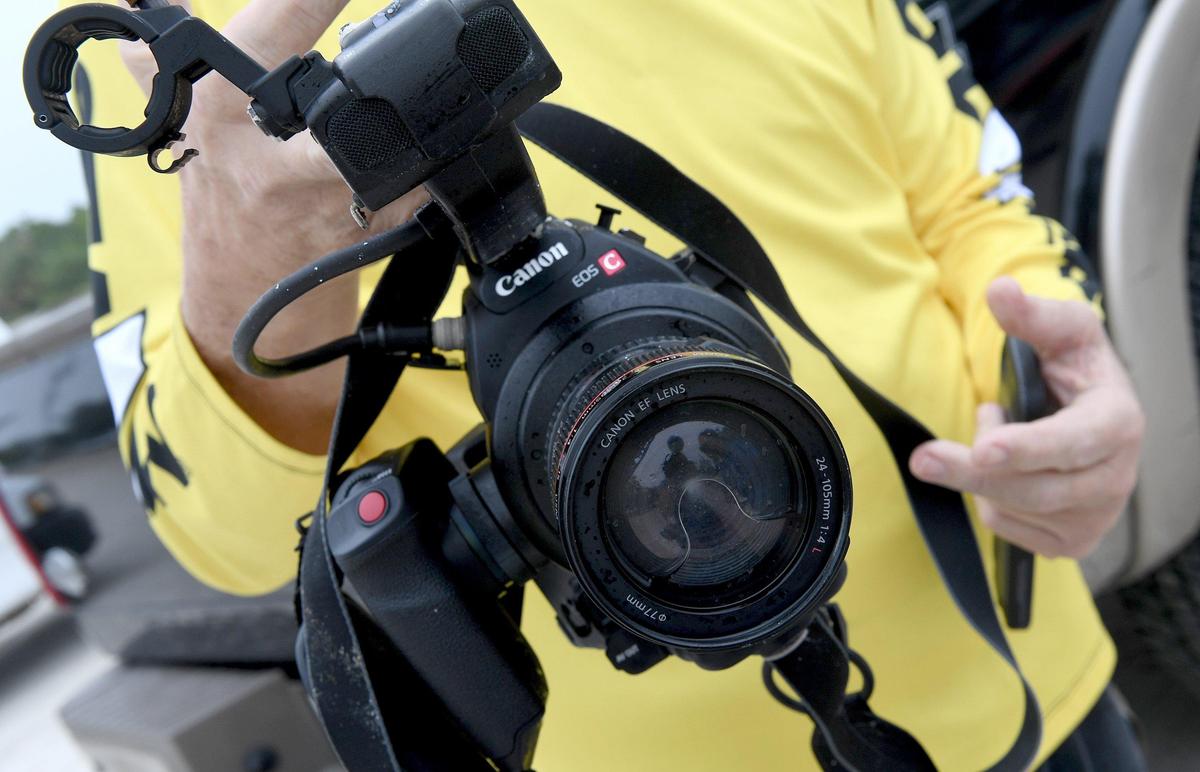 Duke Overstreet of Sea Tow holds a camera recovered from a helicopter that crashed into the Gulf of Mexico and was pulled from the waters and loaded onto a flat bed truck at Coquina Boat ramp for transportation to a secure facility.