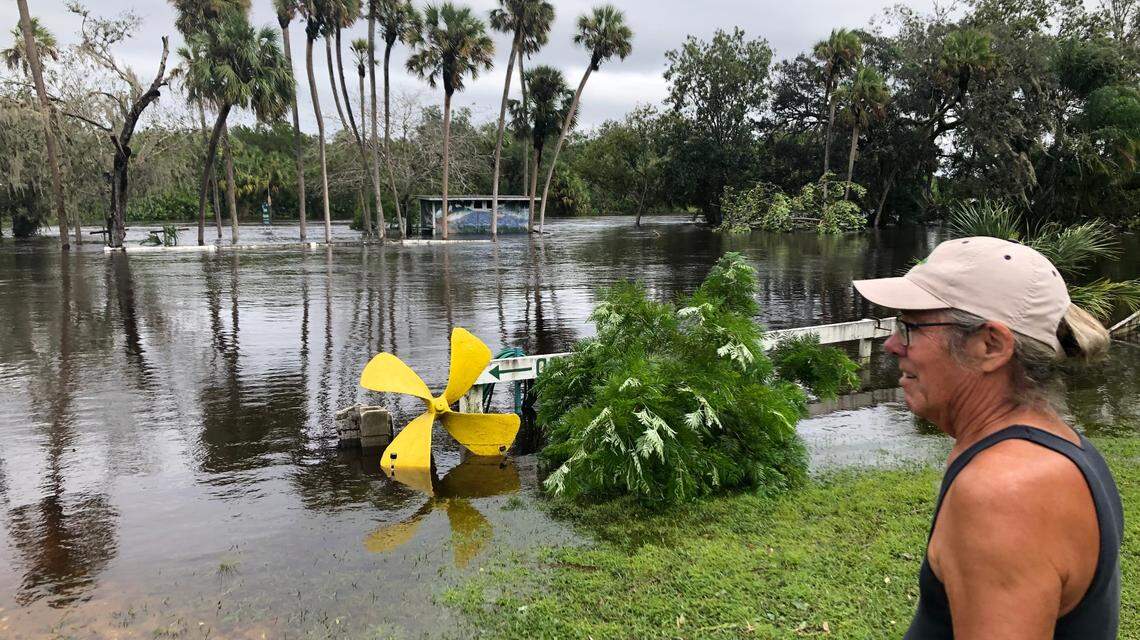 Mark Stukey watches the Manatee River overflow its banks and flood his business, Ray’s Canoe Hideaway off Upper Manatee River Road, on Thursday.