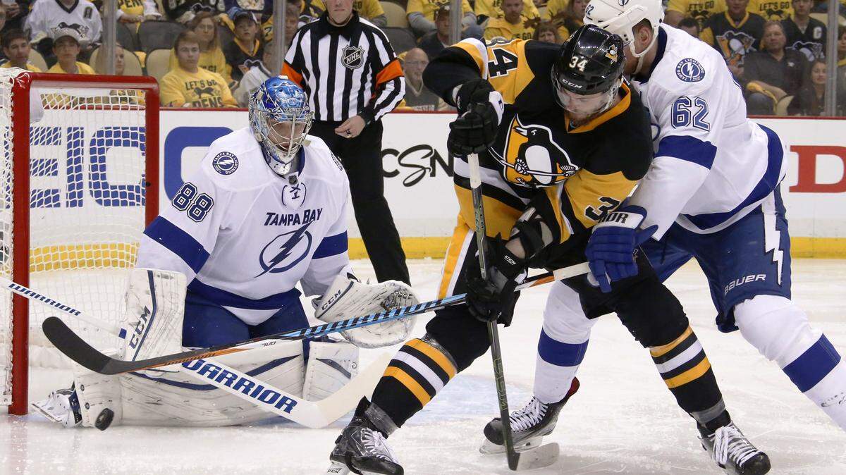 Tampa Bay Lightning goalie Andrei Vasilevskiy (88) stops the puck as Pittsburgh Penguins' Tom Kuhnhackl (34) and Lightning's Andrej Sustr (62) tangle in front of the net during the second period of Game 1 of the NHL hockey Stanley Cup Eastern Conference finals Friday, May 13, 2016, in Pittsburgh. (AP Photo/Gene J. Puskar)
