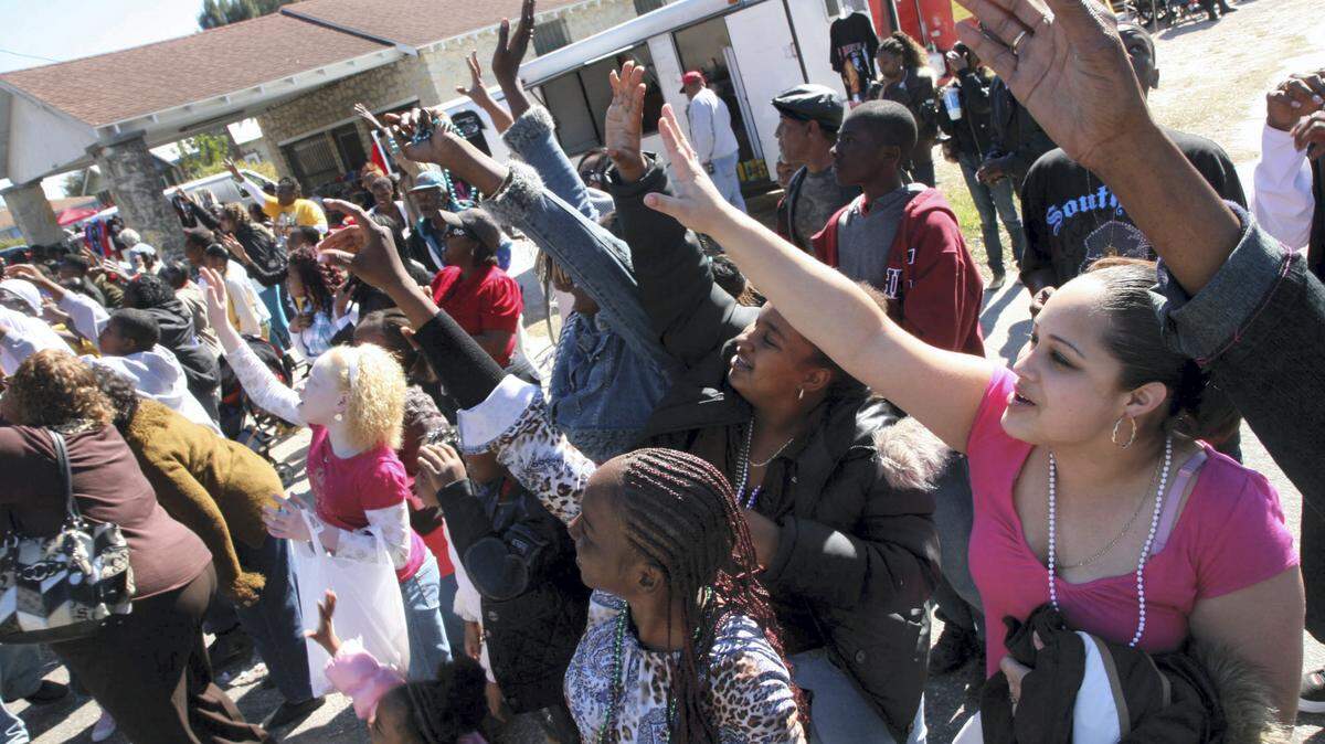 Parade spectators reach out for candy and beads during a past Martin Luther King Jr. Parade in Palmetto. 
 HERALD FILE PHOTO