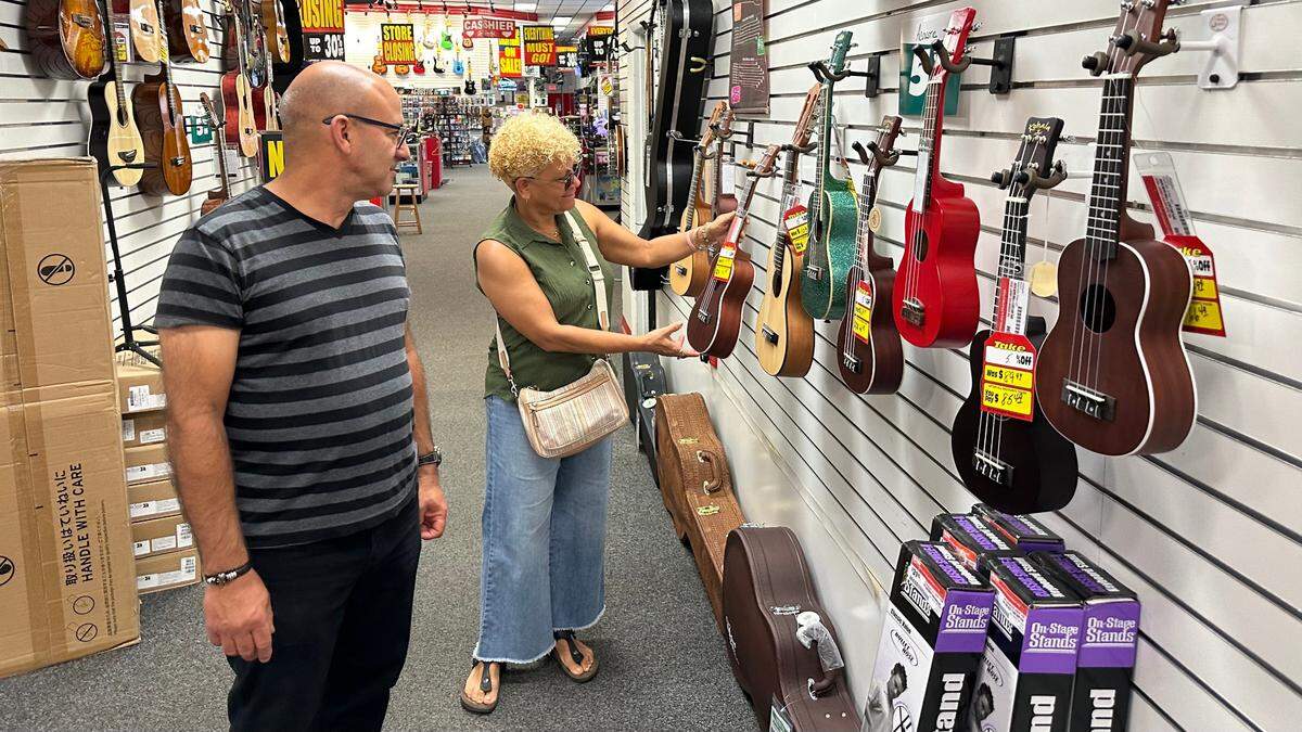 Vladimir Gonzalez and Edna Aguiler were among the customers who visited the Sam Ash Music store at 7606 N. Tamiami Trail on Monday.