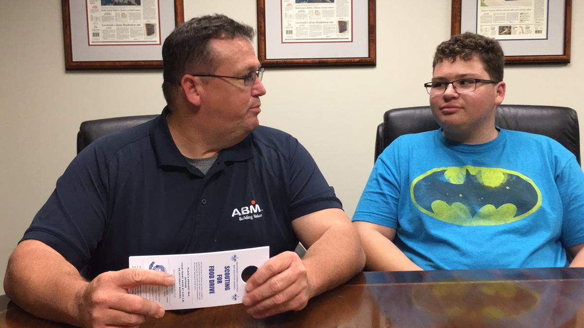 Boy Scout Troop 10 leader Bowdie Williams, left, and his son, Dawson, 16, right, will take part in the national "Scouting For Food Drive" Saturday. Troop 10 is based in Oneco. 
 RICHARD DYMOND/Bradenton Herald