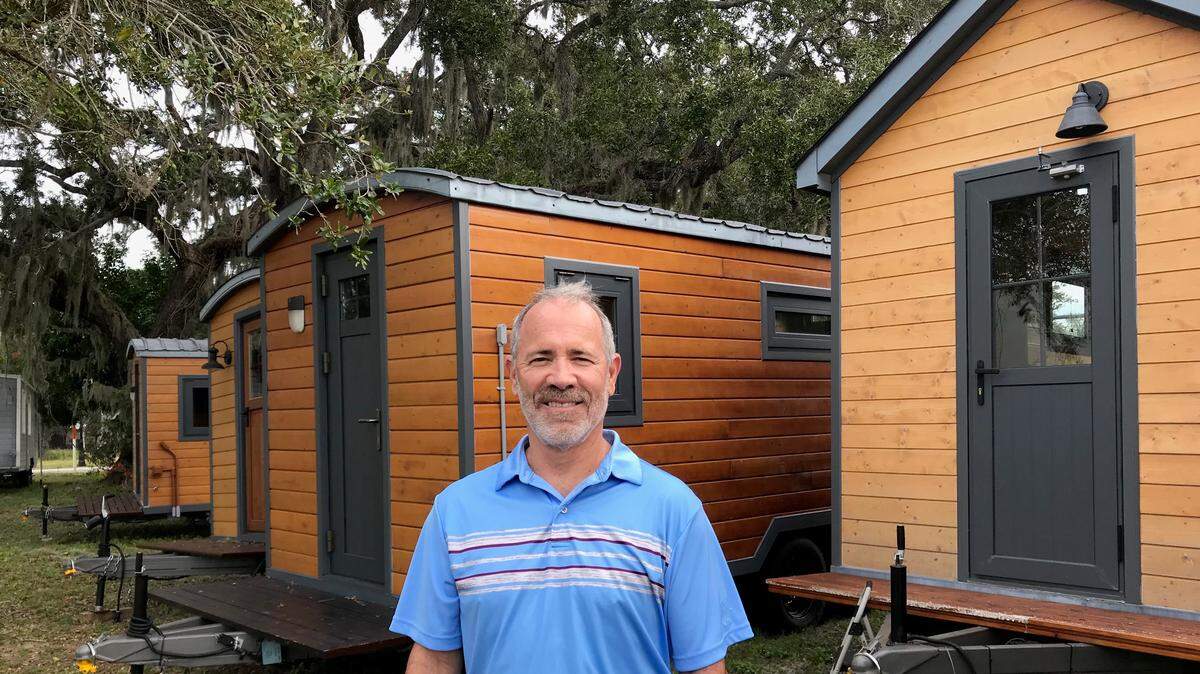 Mike Dixon is shown with some of his tiny houses that will be used in an existing RV camp in Wildwood. These tiny houses were manufactured in China. In the future, Dixon hopes to manufacture his own product line in the United States, perhaps in the Bradenton area.