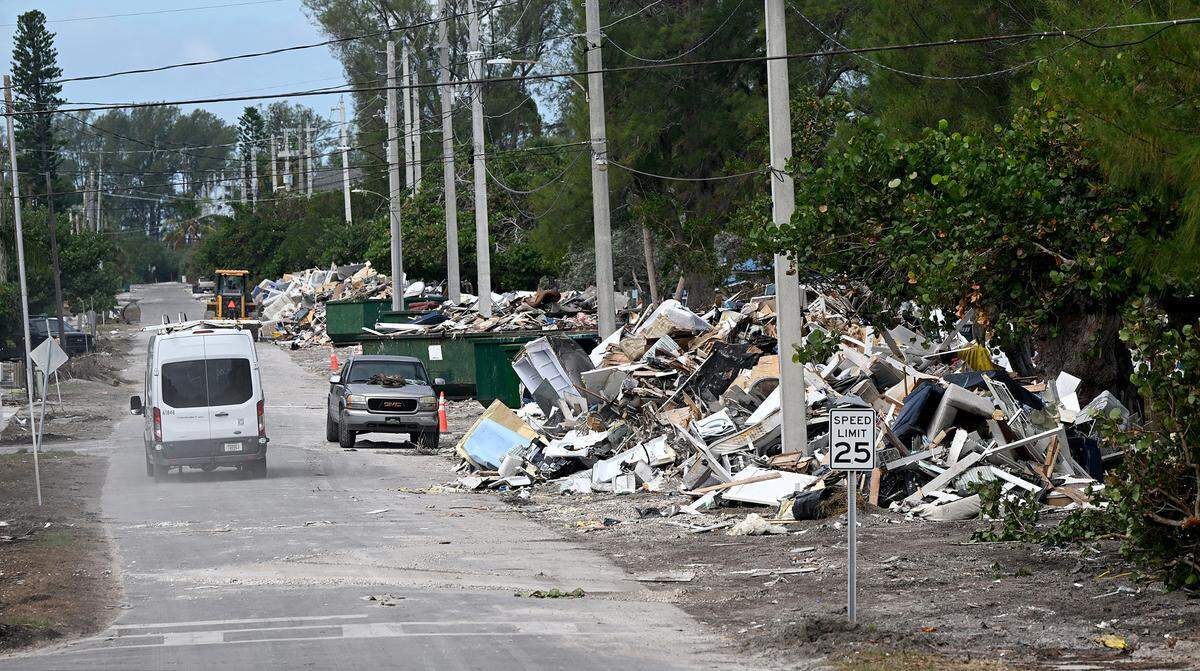 A massive amount of storm debris is stacked on N. Bay Drive on Anna Maria Island where dump trucks come haul away loads as Hurricane Milton approaches Manatee County on Oct. 8, 2024.