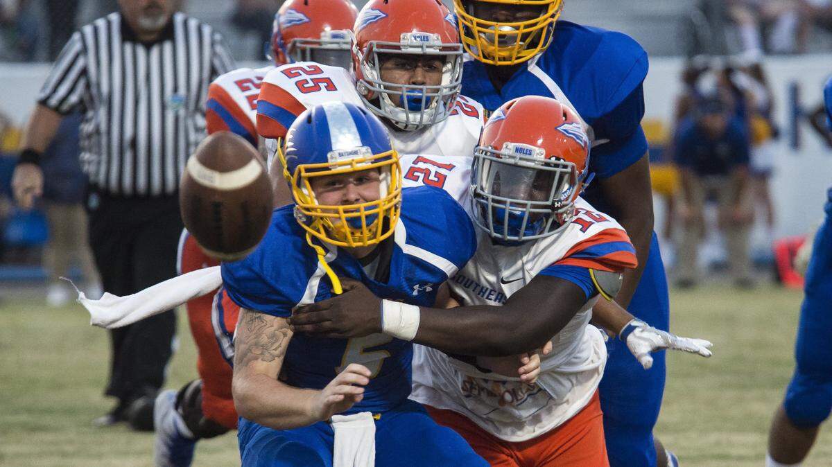 Bayshore’s Corey Vonborstel loses control of the ball after Southeast’s Kam’ron Green strips it during the 2017 high school football season.