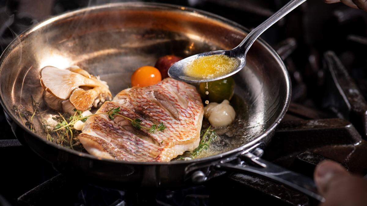 Pan Seared Red Snapper served with wilted spinach, arancini cake, caponata, and citrus butter is one of the menu offerings at Shore Longboat Key.