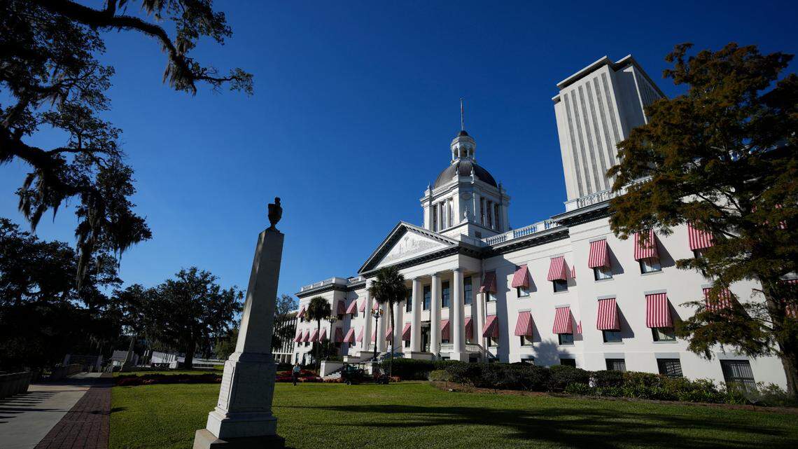 The old Florida Capitol building is seen, with the new Capitol building tower rising behind, during a special legislative session in 2021, in Tallahassee, Fla.
