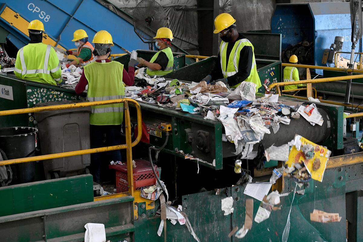 Workers sort through recycling at Waste Pro at 7921 15th Street East, Sarasota.