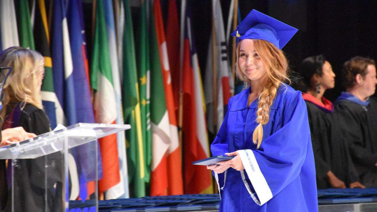 An IMG Academy graduate accepts her diploma at the 19th annual commencement ceremony on Friday night.
