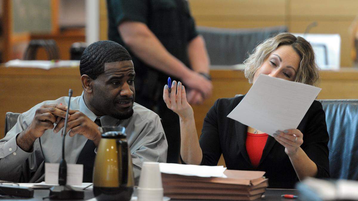 Everrick Houston talks with his attorney Jenna Finkelstein during jury selection Monday. Houston, 34, is charged with two counts of first-degree murder and one count armed burglary. 
 GRANT JEFFERIES/Bradenton Herald