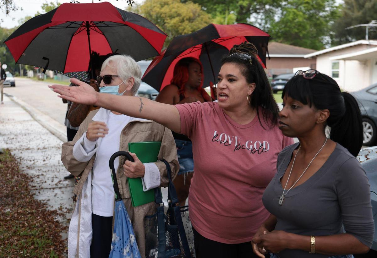 Evicted former resident Nairobys Toledo, center, demands that Bradenton Housing Authority Executive Director Ellis Mitchell Jr. meet with the group of women as he and workers clear out a house where a tenant was formerly evicted. Public housing advocate Shavonda Griffin, right, and others wait for Mitchell to exit the house as he continued to stay inside.