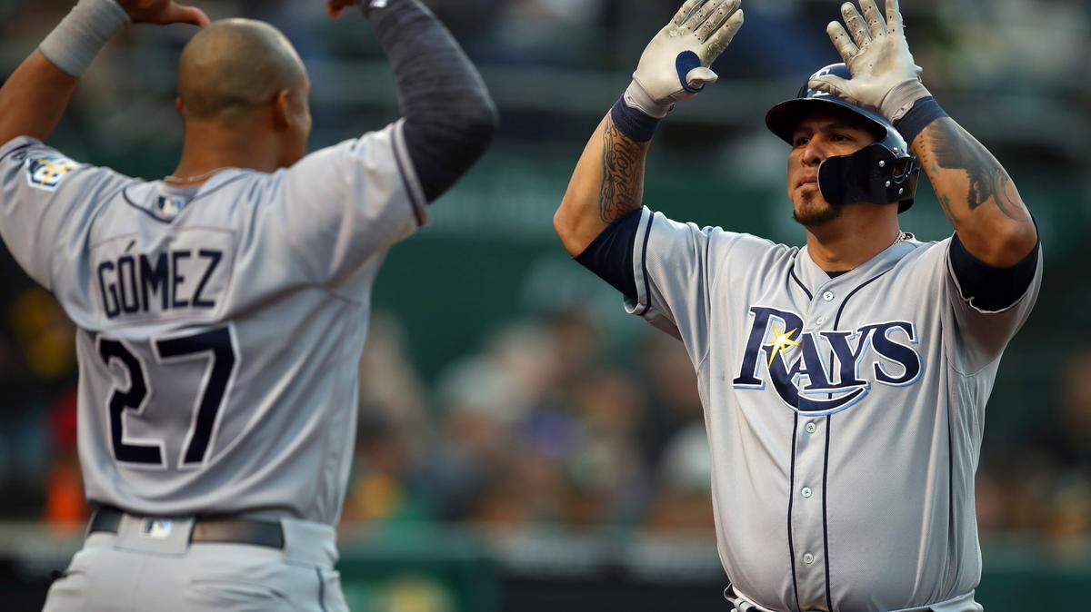 Tampa Bay Rays' Wilson Ramos, right, is congratulated by Carlos Gomez (27) after hitting a home run off Oakland Athletics' Daniel Gossett during the third inning of a baseball game Tuesday, May 29, 2018, in Oakland, Calif.