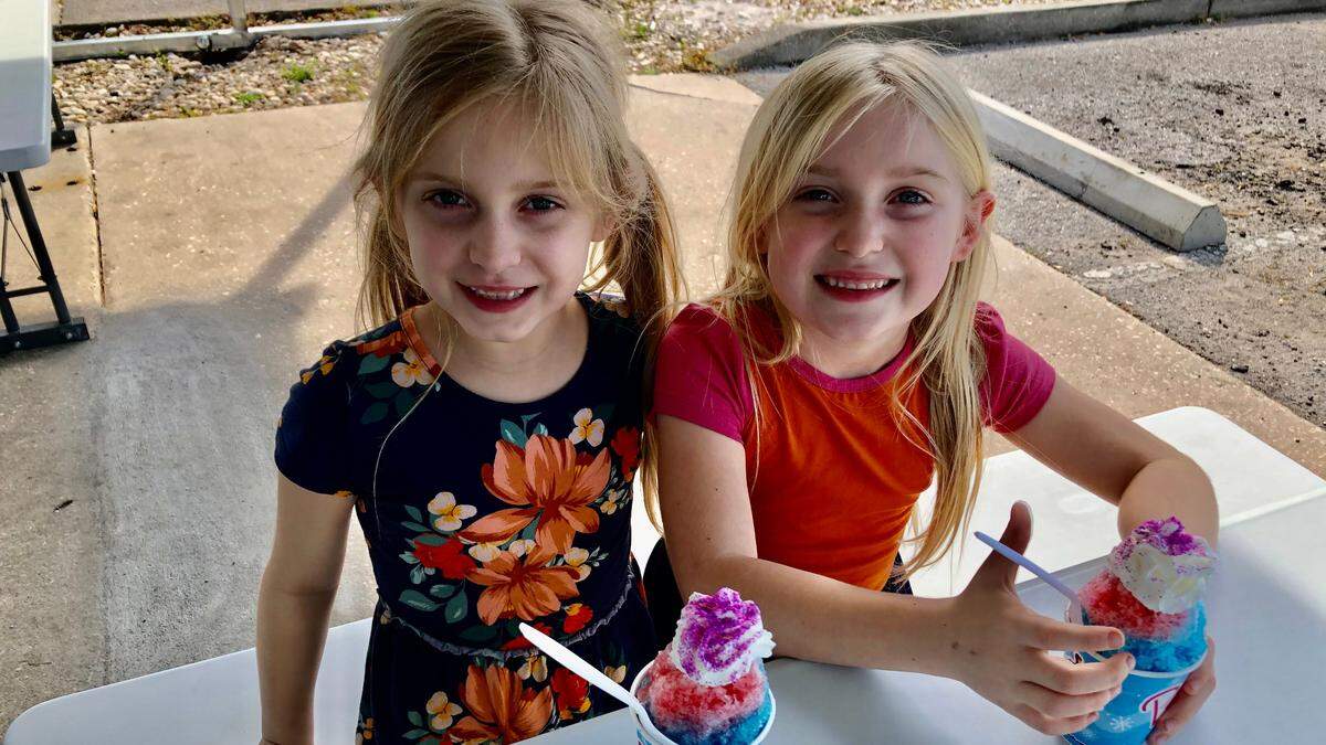 1/27/2021--Ellie, left, and her twin sister Olivia Dzikas prepare to dig into their Unicorns at Pelican’s SnoBalls in Palmetto on Wednesday.