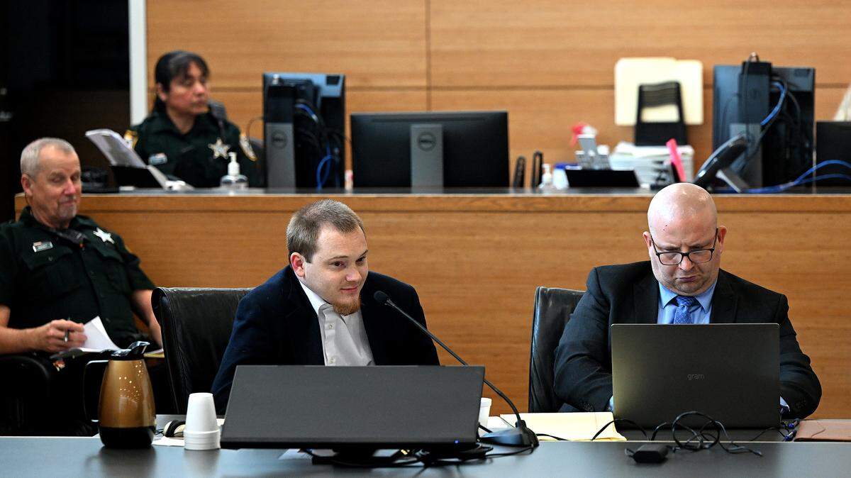 Nicholas Bassler, 27, appears in a Manatee County courtroom with attorney William Wynne ahead of his trial that includes charges of capital sexual battery, lewd or lascivious conduct and possession of child sexual abuse material, according to court records, on Dec. 8, 2025.