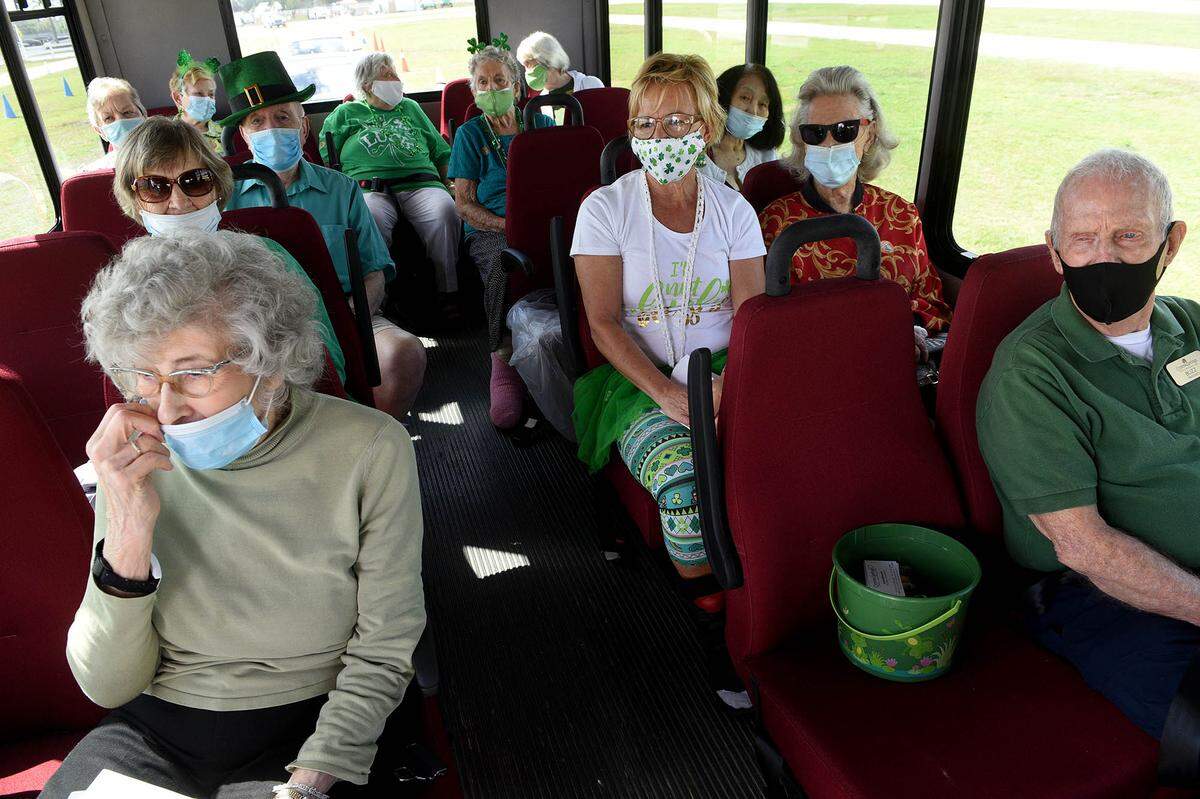 03/17/21--Kay Oberstar, left, is 100 years old. She was one of a small busload of seniors from Cypress Springs receiving a second dose of the COVID-19 vaccine at the Premier Sports Complex in Lakewood Ranch.
