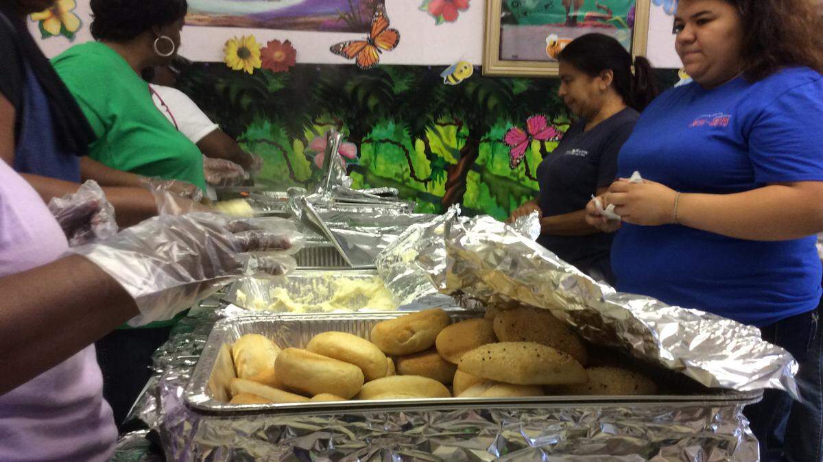 Members of Praise and Deliverance Ministries International, Inc., 2309 14th St. W., Bradenton serve people a Thanksgiving meal during an event at the church for people in need on Saturday. 
 JESSICA DE LEON/Bradenton Herald