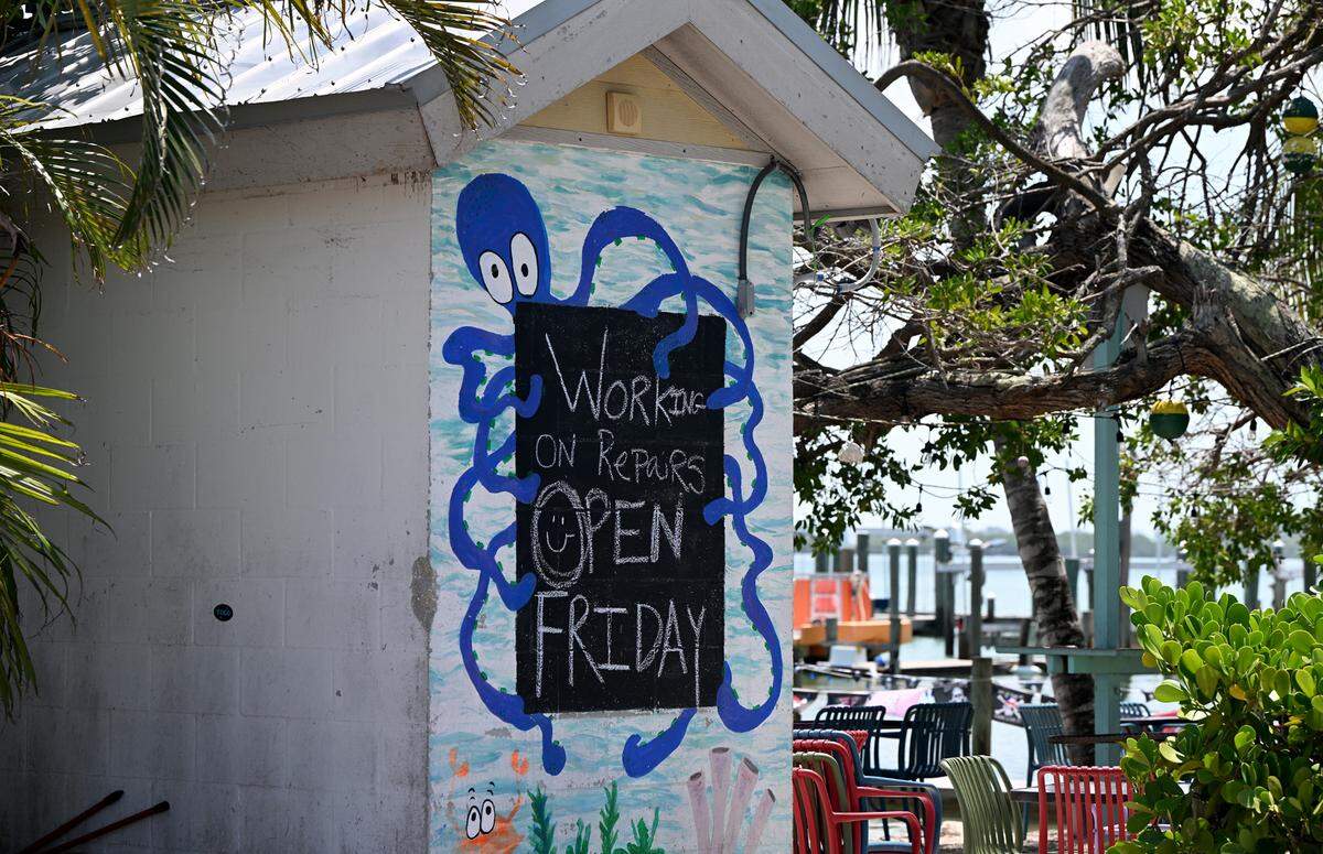 A sign advises customers that The Bridge Tender will open on Friday after Hurricane Idalia passed on August 31, 2023.
