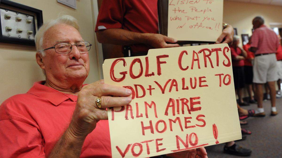 Palm Aire resident Frank Darling shows his opposition to banning golf carts on Whitfield during a meeting of the Manatee County Commission on Tuesday.GRANT JEFFERIES/Bradenton Herald